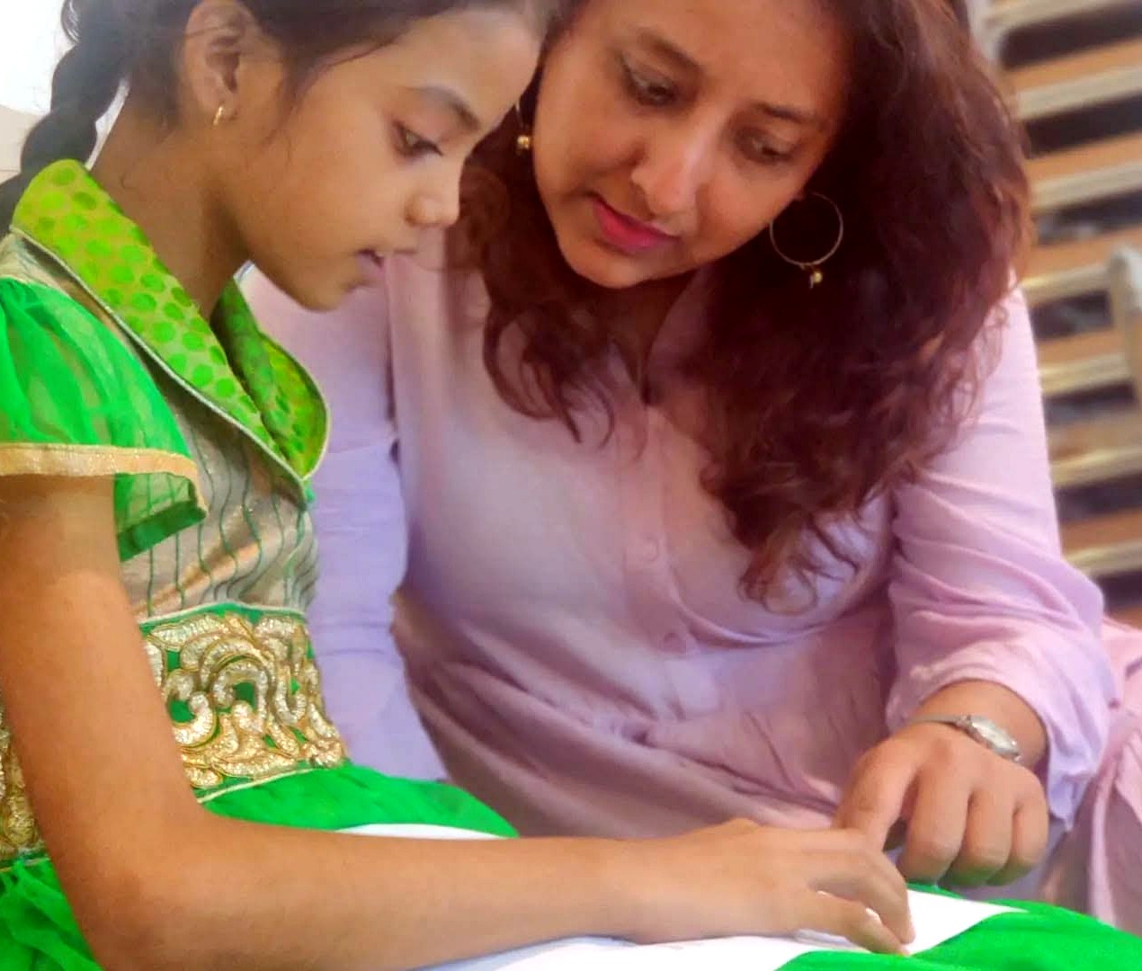 A mentor reading one-to-one with a child at Touching Lives